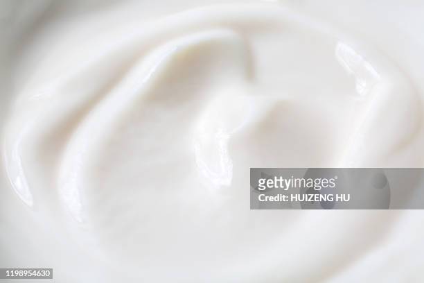 natural yogurt. close up of the yogurt texture - jogurt textur stock-fotos und bilder