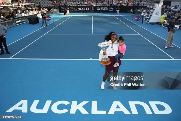 Serena Williams of the USA holds her daughter Alexis Olympia with the trophy following the Women's Final between Serena Williams and Jessica Pegula...