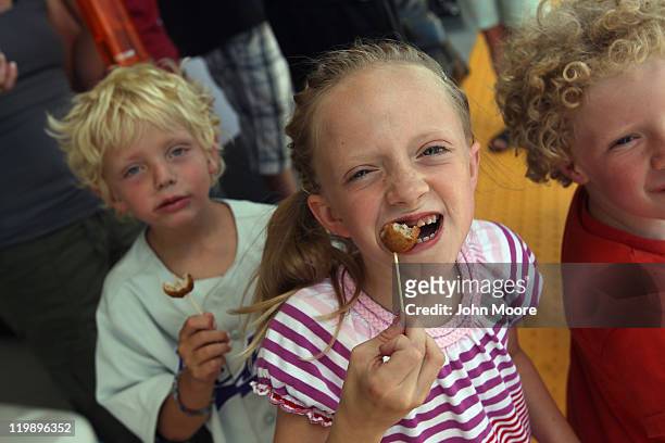 Sofia Hickey eats free Swedish meatballs handed by Ikea to customers and their families awaiting the grand opening of the new Ikea home furnishings...