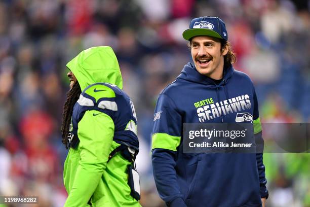 Marshawn Lynch of the Seattle Seahawks warms up, and shares a laugh with Luke Willson before the game against the San Francisco 49ers at CenturyLink...