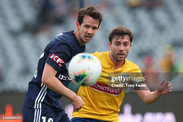 Robbie Kruse of Melbourne Victory contests the ball with Tommy Oar of the Central Coast Mariners during the round 14 A-League match between the...