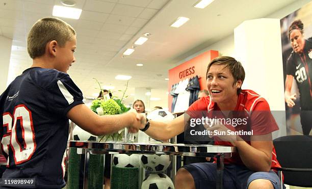 Abby Wambach, a member of the U.S. Women's soccer team, greets eight-year-old Gunnar Hansen in Boca Raton, Florida, on Tuesday, July 26, 2011.