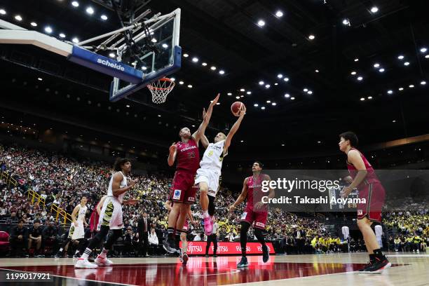 Leo Vendrame of Sun Rockers Shibuya lays the ball up while under pressure from Nick Fazekas of Kawasaki Brave Thunders during the basketball...