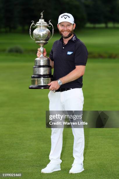 Branden Grace of South Africa celebrates with the trophy after winning the tournament during Day Four of the South African Open at Randpark Golf Club...