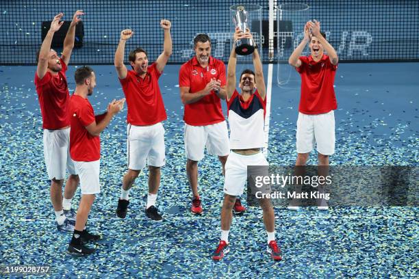 Novak Djokovic and team Serbia celebrate winning the ATP Cup final against Spain during day 10 of the ATP Cup at Ken Rosewall Arena on January 12,...
