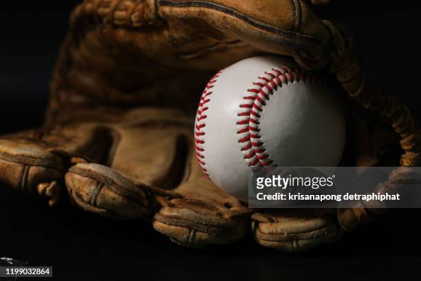 glove and baseball on a black background, no background people are excellent. - infield foto e immagini stock