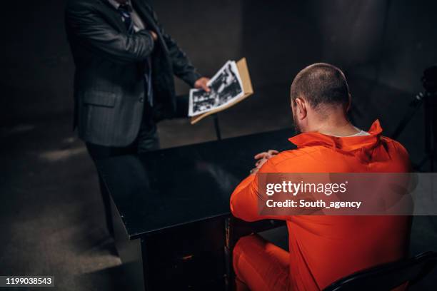 prisoner and detective - prison jumpsuit stock pictures, royalty-free photos & images