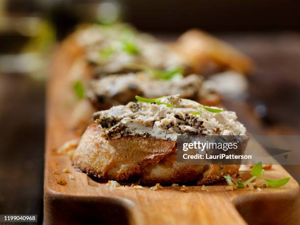 peppered goat cheese crostini with micro basil - goat cheese stock pictures, royalty-free photos & images