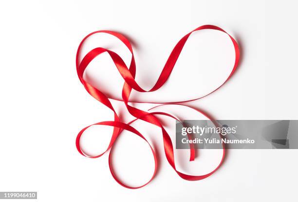 red ribbon smoked curl isolated on white background. ribbon pattern. - build presents suits fotografías e imágenes de stock