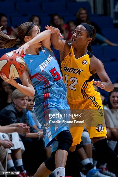Shalee Lehning of the Atlanta Dream is trapped by Ivory Latta of the Tulsa Shock during the WNBA game on July 26, 2011 at the BOK Center in Tulsa,...