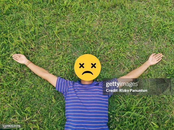 emoji face against grass background - scrunched up face stock pictures, royalty-free photos & images