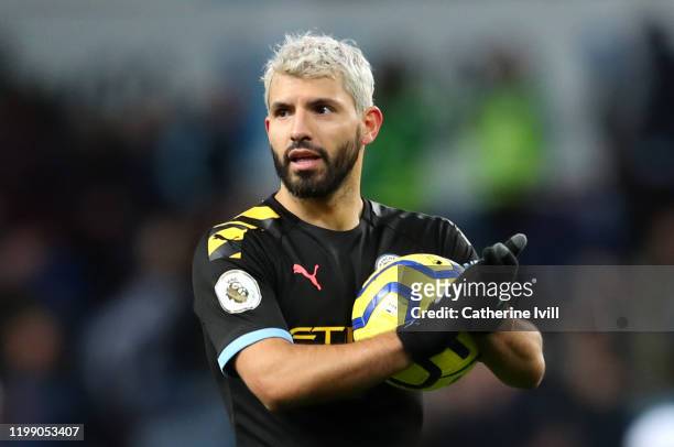 Sergio Aguero of Manchester CIty celebrates victory with the match ball after he scored a hat-trick during the Premier League match between Aston...