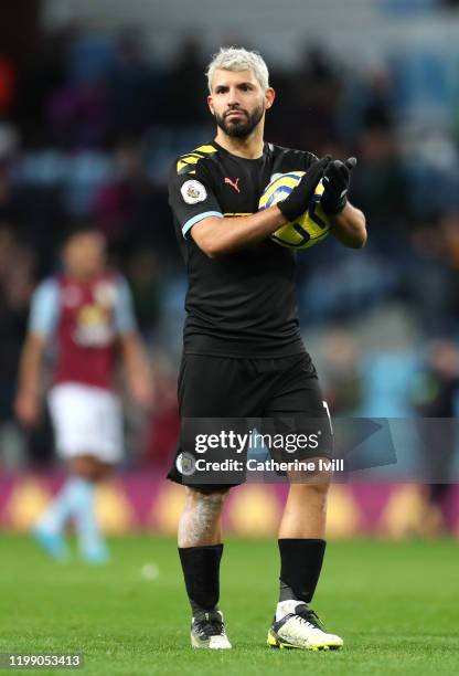 Sergio Aguero of Manchester CIty celebrates victory with the match ball after he scored a hat-trick during the Premier League match between Aston...