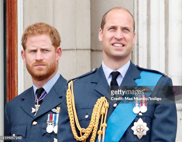Prince Harry, Duke of Sussex and Prince William, Duke of Cambridge watch a flypast to mark the centenary of the Royal Air Force from the balcony of...