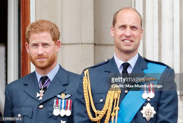 Prince Harry, Duke of Sussex and Prince William, Duke of Cambridge watch a flypast to mark the centenary of the Royal Air Force from the balcony of...