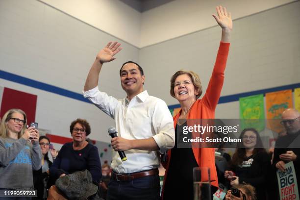 Former housing secretary Julian Castro joins Democratic presidential candidate Sen. Elizabeth Warren during a campaign stop at Fisher Elementary...