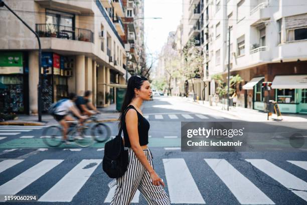 young woman crossing the street in buenos aires, argentina - la recoleta stock pictures, royalty-free photos & images