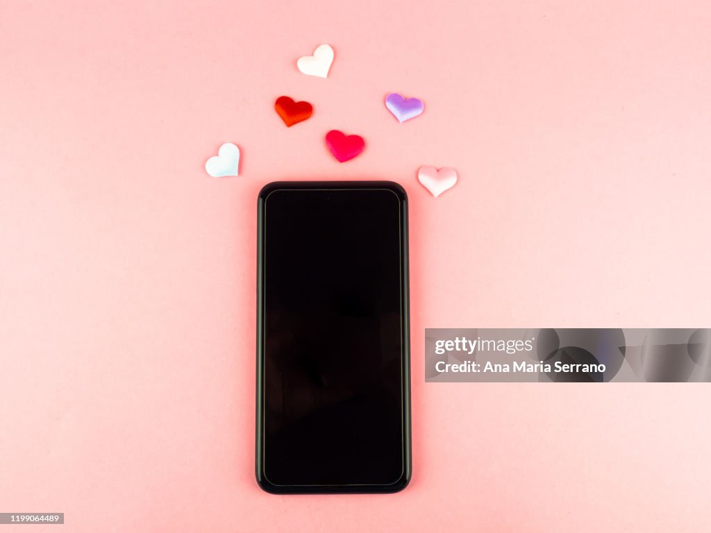 A smartphone with hearts. Concept of love on the internet and social networks