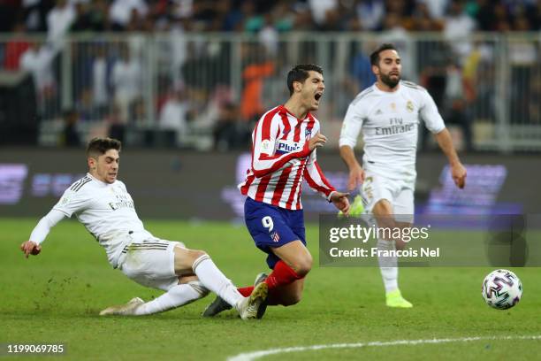 Federico Valverde of Real Madrid tackles Alvaro Morata of Atletico Madrid which results in the red card being shown to Federico Valverde of Real...