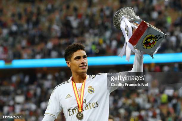 Raphael Varane of Real Madrid celebrates with the trophy after his teams victory in the Supercopa de Espana Final match between Real Madrid and Club...