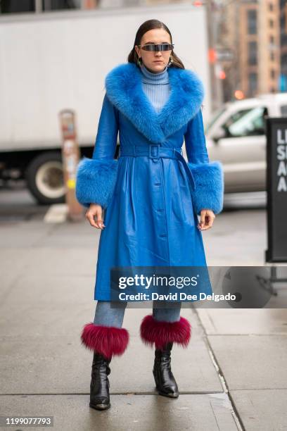 Elizaveta Kozlova Wears a coat by Saks Potts and Glasses by Pierre Cardin to NYFW on February 6, 2020 in New York City.