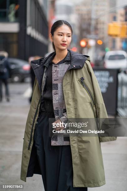Yongshin Chen wears a complete outfit by Oqliq to NYFW on February 6, 2020 in New York City.