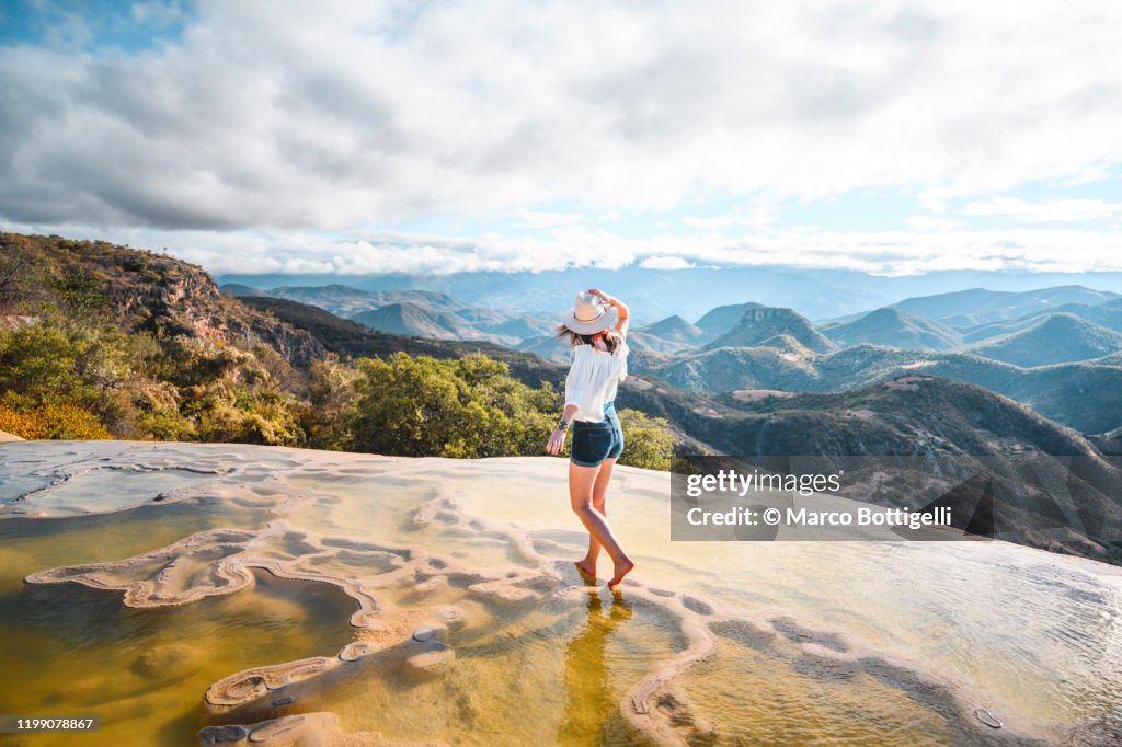 Woman walking on the limestone rock formations at Hierve el Agua, Oaxaca, Mexico