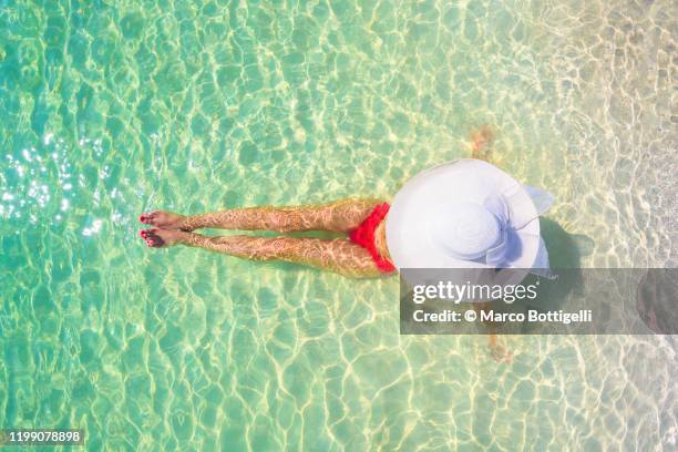 woman relaxing on the beach in playa del carmen, quintana roo, mexico - playa del carmen stock pictures, royalty-free photos & images