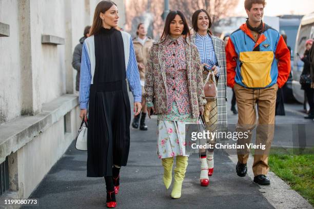 Giorgia Tordini wearing black white blue striped multi colored dress, Amina Muaddi wearing mixed pattern, Gilda Ambrosio wearing Prada bag, yellow...