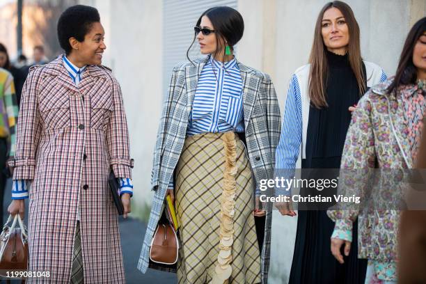 Tamu McPherson wearing checkered coat, Gilda Ambrosio wearing striped button shirt, yellow skirt, coat and Giorgia Tordini wearing black multi...