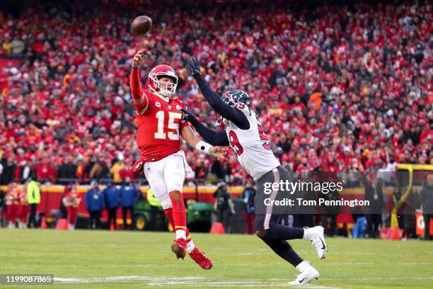 Patrick Mahomes of the Kansas City Chiefs attempts a pass under pressure from J.J. Watt of the Houston Texans during the third quarter in the AFC...