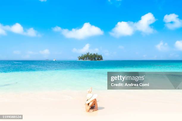young woman relaxing on a tropical beach. san blas islands, panama - einsame insel stock-fotos und bilder