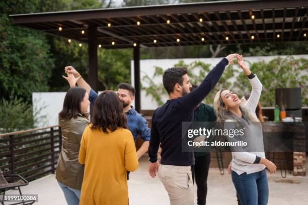 group of young friends dancing - balcony party stock pictures, royalty-free photos & images