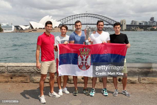 Novak Djokovic, Dusan Lajovic, Nenad Zimonjic, Viktor Troicki and Nikola Cacic of Team Serbia pose with the ATP Cup during a media opportunity after...