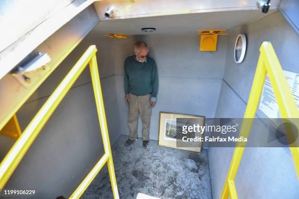 Donald Graham stands inside his underground bushfire bunker with an 1867 lithograph by colonial artist, Eugene Von Guerard, January 11, 2020. The...