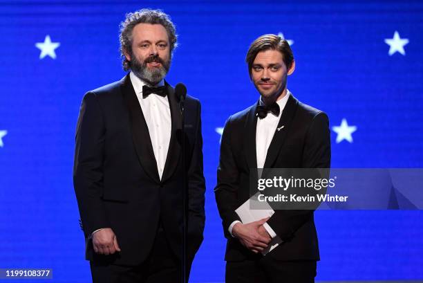 Michael Sheen and Tom Payne speak onstage during the 25th Annual Critics' Choice Awards at Barker Hangar on January 12, 2020 in Santa Monica,...