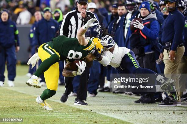 Jadeveon Clowney of the Seattle Seahawks tackles Jace Sternberger of the Green Bay Packers out of bounds during the first half in the NFC Divisional...