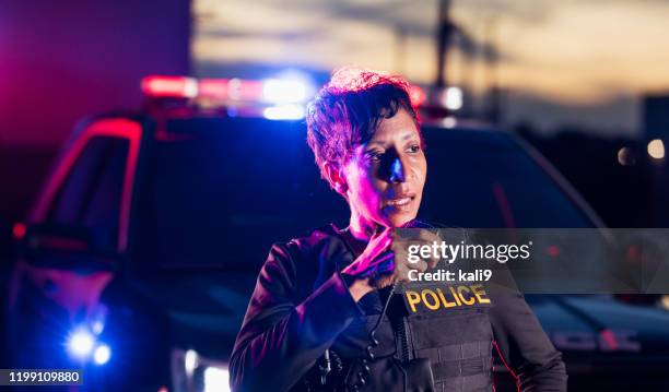 african-american policewoman talking on radio - maritime police stock pictures, royalty-free photos & images