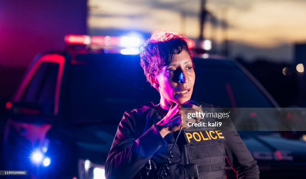 African-American policewoman talking on radio