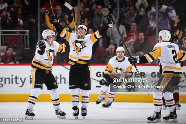 Juuso Riikola, Brandon Tanev, Teddy Blueger and Chad Ruhwedel of the Pittsburgh Penguins celebrate after Tanev scored a goal against the Arizona...