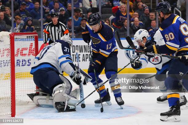 Jaden Schwartz of the St. Louis Blues looks to score a goal against Connor Hellebuyck of the Winnipeg Jets at the Enterprise Center on February 6,...