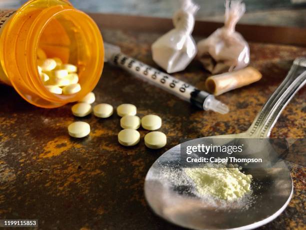 narcotic opiate drugs, heroin, and cocaine with syringe and spoon - opiates stock pictures, royalty-free photos & images