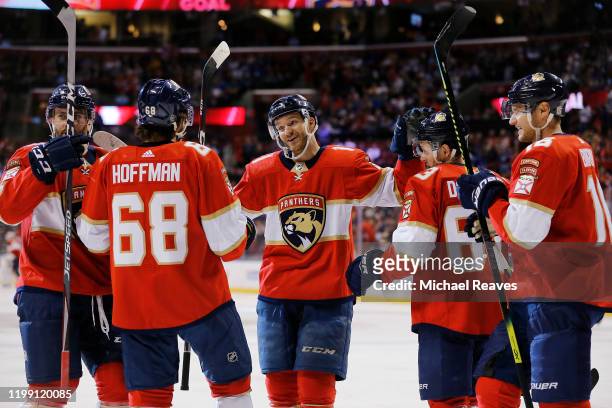 Jonathan Huberdeau of the Florida Panthers celebrates with teammates after assisting a goal which made him the the all-time Florida Panthers leader...