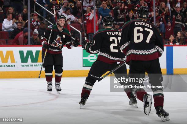 Niklas Hjalmarsson, Derek Stepan and Lawson Crouse of the Arizona Coyotes celebrate after Stepan scored a goal against the Pittsburgh Penguins during...