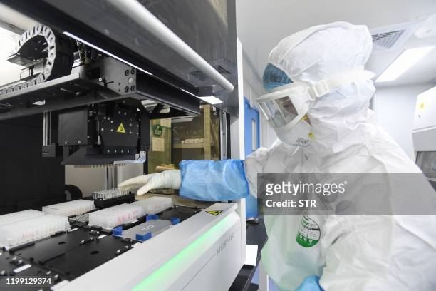 This photo taken on February 6, 2020 shows a laboratory technician working on samples from people to be tested for the new coronavirus at "Fire Eye"...