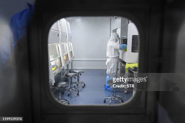 This photo taken on February 6, 2020 shows a laboratory technician working on samples from people to be tested for the new coronavirus at "Fire Eye"...