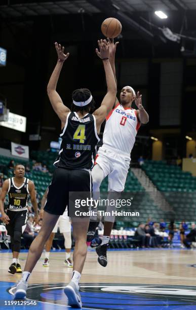 Donte Grantham of the Agua Caliente Clippers shoots over Moses Brown of the Texas Legends during the second quarter on February 06, 2020 at Comerica...