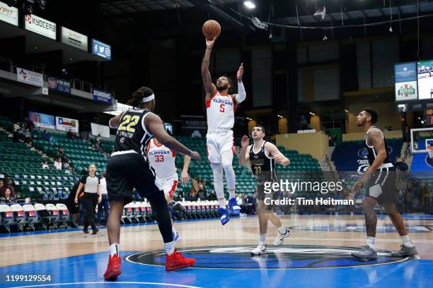 Markel Crawford of the Agua Caliente Clippers shoots over Chad Brown of the Texas Legends and Dakota Mathias of the Texas Legends during the first...
