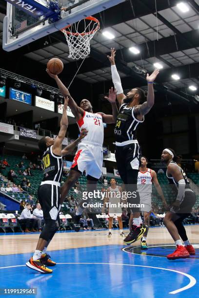 Tyler Roberson of the Agua Caliente Clippers shoots against Jahmal McMurray of the Texas Legends and Isaac Copeland of the Texas Legends during the...