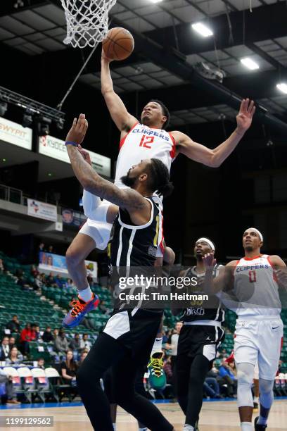 James Palmer of the Agua Caliente Clippers dunks over Isaac Copeland of the Texas Legends during the second quarter on February 06, 2020 at Comerica...